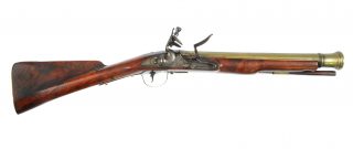 English blunderbuss firearm with a wood stock and flared brass barrel