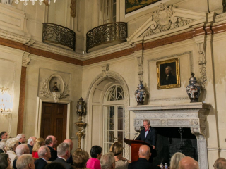 Lecturer at the fireplace in the Ballroom. Photo by Jeremy Chou.