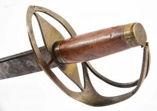 Brass and cherry hilt of the sword of Massachusetts minute man James Taylor viewed at an angle