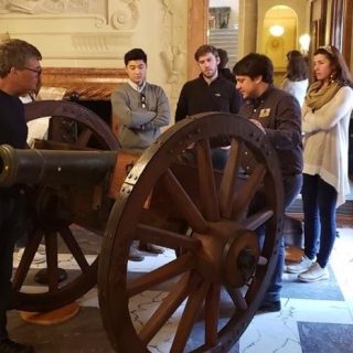 Evan Phifer explains a cannon to teachers at the American Revolution Institute headquarters.