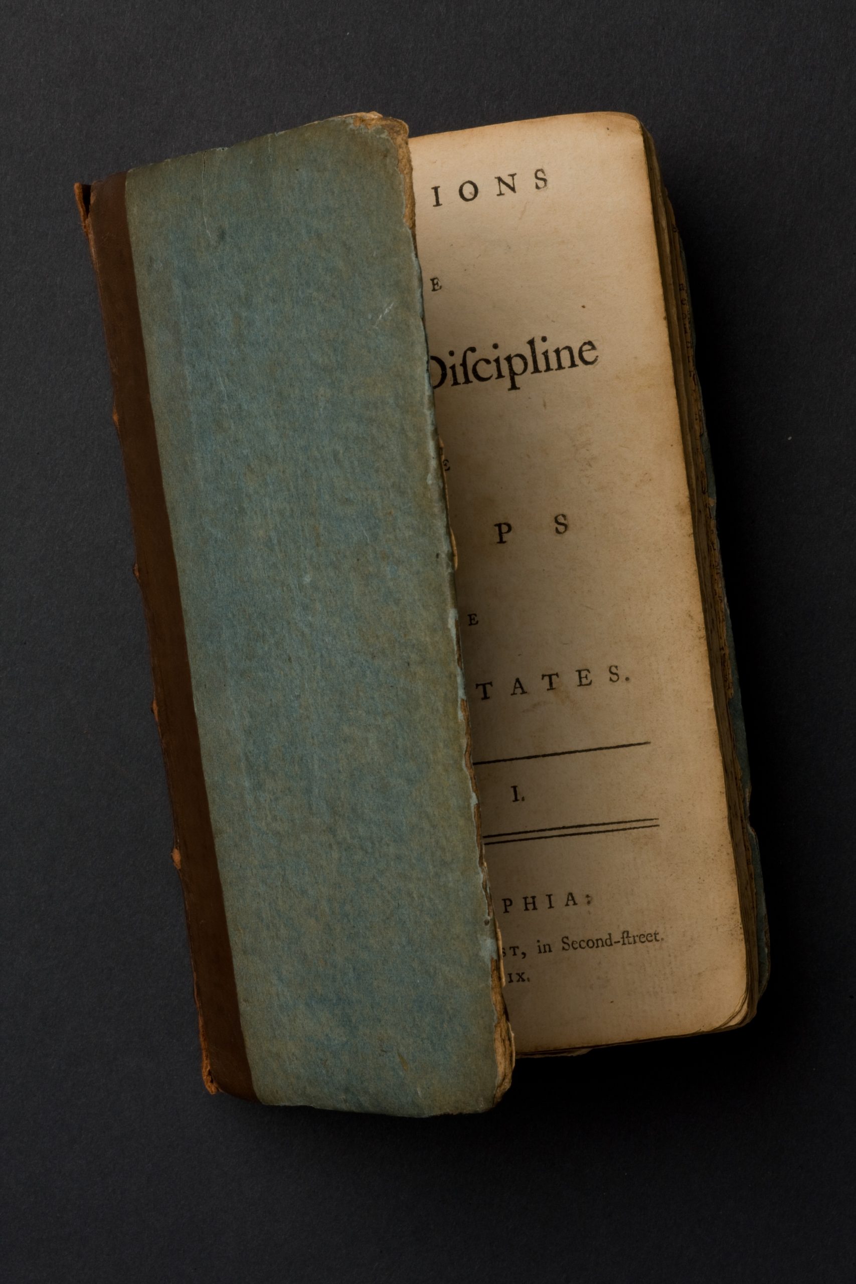 The blue paper-covered board binding of Baron von Steuben's Regulations for the Order and Discipline of the Troops