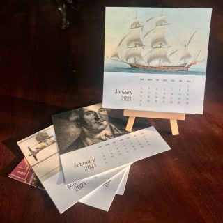 Desk calendar of individual cards with images of Institute collections with a wooden easel