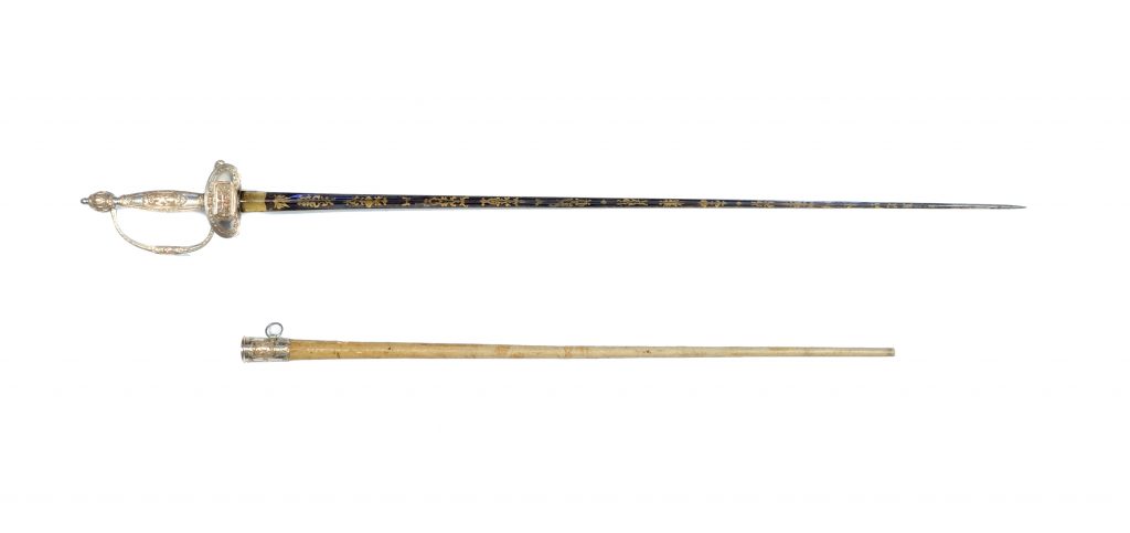 Gold and silver decorated presentation sword alongside a shagreen-covered scabbard