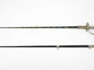 Click for a larger view. Gold and silver decorated presentation sword alongside a black leather scabbard