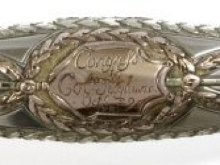 Detail of an inscription engraved on the silver grip of a presentation sword