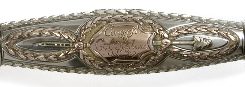 Detail of an inscription engraved on the silver grip of a presentation sword
