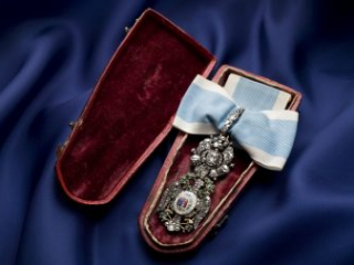 Click for a larger view. Bejeweled insignia resting inside a red velvet-lined case