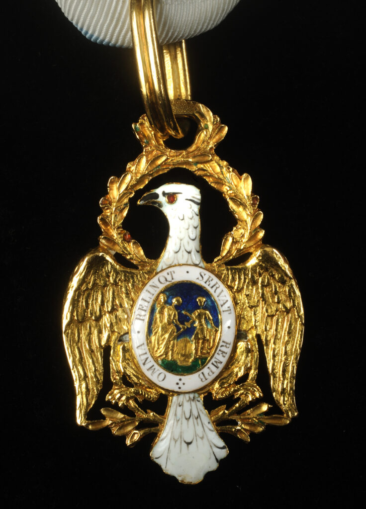 Gold eagle-shaped insignia of the Society of the Cincinnati with white enamel decoration