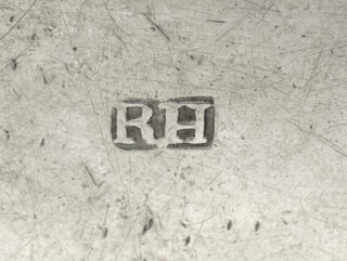 Stamped initials RH on a silver surface