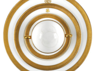 Click for a larger view. Three circular gold-and-white plates of different sizes stacked