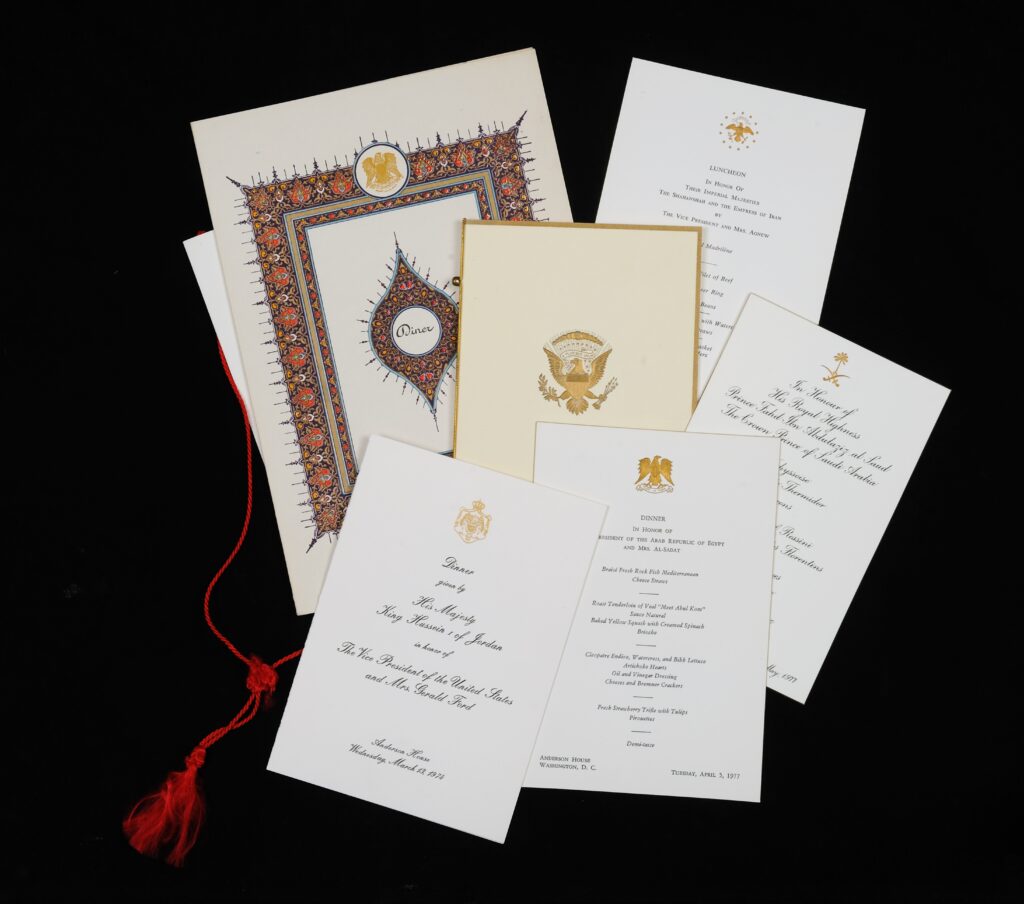 A selection of formal printed and embossed invitations and menus