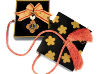 Click for a larger view Orange and blue medal with an orange and red ribbon in a black and gold box with red cords