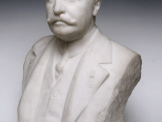 Click for a larger view. Marble bust of a man with a mustache wearing a suit and medal