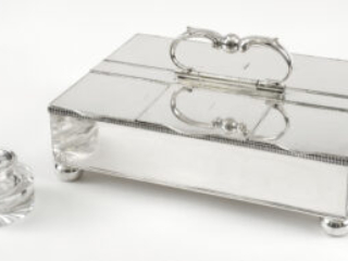 Click for a larger view. Rectangular silver box with a handle next to a glass and silver inkwell